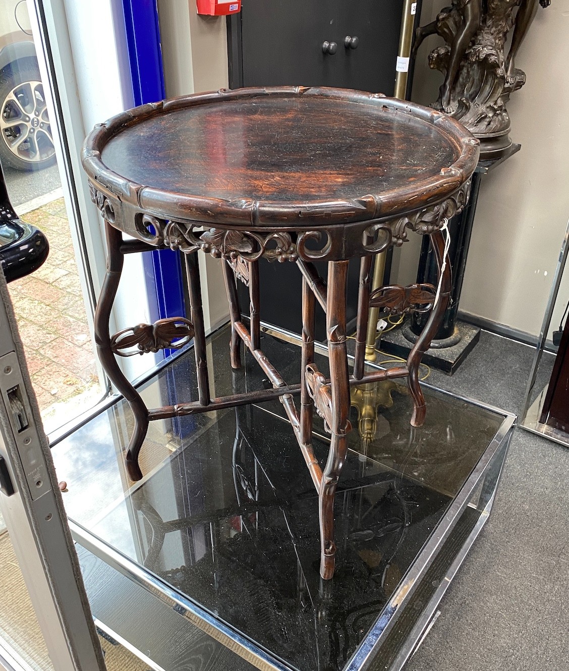 A Chinese circular hardwood tray top occasional table on folding stand, diameter 62cm, height 70cm